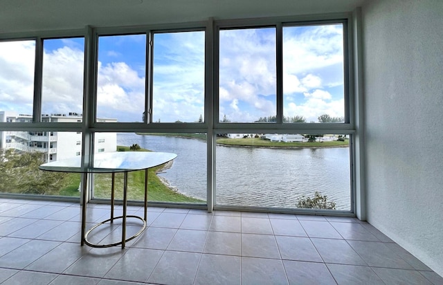 unfurnished sunroom with a water view