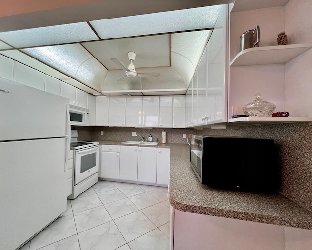 kitchen with ceiling fan, sink, tasteful backsplash, white appliances, and white cabinets