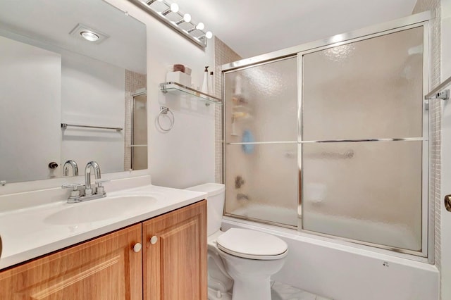 full bathroom with vanity, toilet, and enclosed tub / shower combo