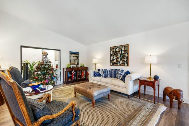 living room featuring wood-type flooring and vaulted ceiling