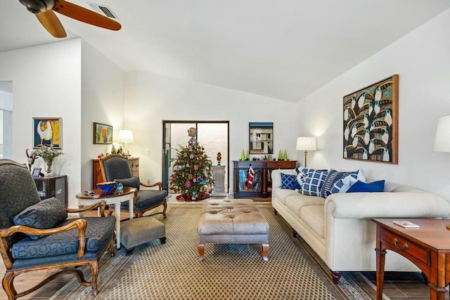 living room featuring tile patterned floors, ceiling fan, and vaulted ceiling