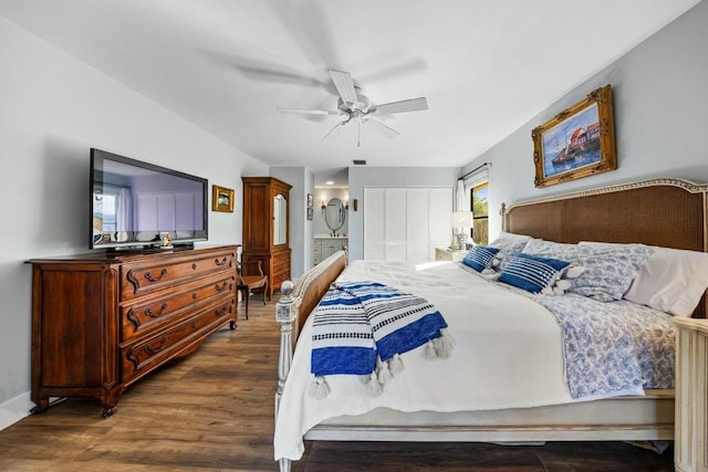 bedroom with ceiling fan, dark wood-type flooring, and connected bathroom