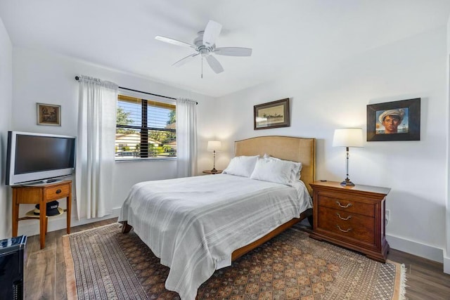 bedroom with ceiling fan and dark hardwood / wood-style flooring