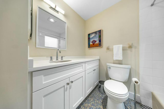 bathroom featuring tile patterned floors, vanity, toilet, and walk in shower