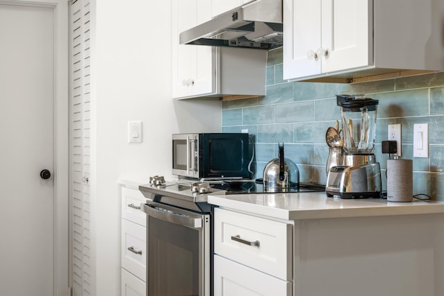 kitchen featuring backsplash, white cabinetry, and stainless steel appliances