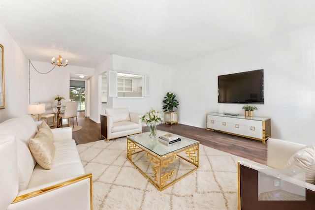 living room with an inviting chandelier and hardwood / wood-style flooring