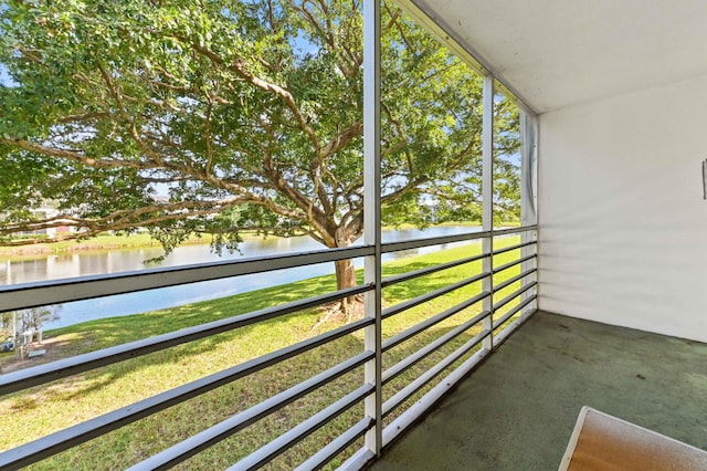 unfurnished sunroom with a water view