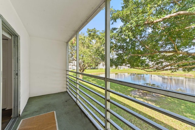 unfurnished sunroom with a water view