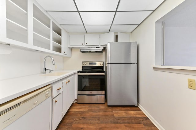 kitchen with white cabinets, appliances with stainless steel finishes, dark hardwood / wood-style flooring, and sink