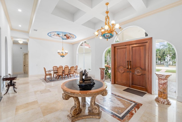 foyer entrance featuring a high ceiling, a healthy amount of sunlight, and coffered ceiling