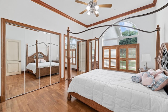 bedroom with ceiling fan, light hardwood / wood-style floors, and ornamental molding