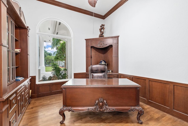 office with light wood-type flooring and ornamental molding