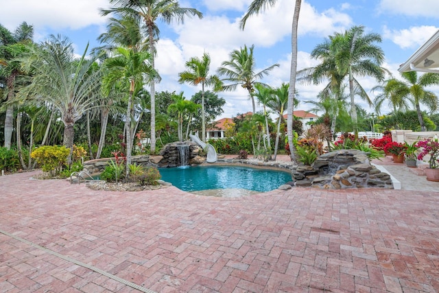 view of pool featuring a patio area and a water slide