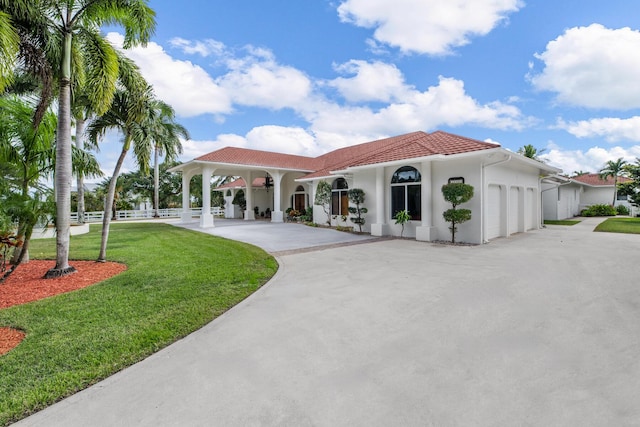 view of front facade with a front yard and a garage