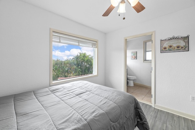 bedroom with ceiling fan, ensuite bathroom, and hardwood / wood-style flooring