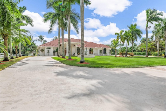 mediterranean / spanish-style home featuring a front yard