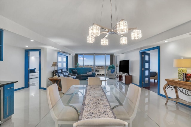 dining space with light tile patterned floors, a notable chandelier, and a wall of windows