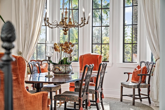 dining space with an inviting chandelier and a healthy amount of sunlight