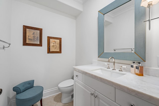 bathroom with tile patterned flooring, vanity, crown molding, and toilet