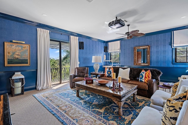 carpeted living room with ceiling fan and ornamental molding