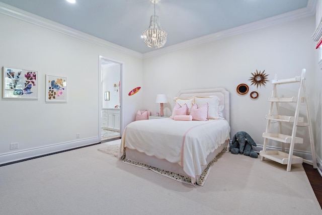 bedroom featuring crown molding, ensuite bathroom, and a chandelier