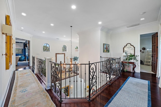 hall with ornamental molding, a notable chandelier, and dark hardwood / wood-style flooring