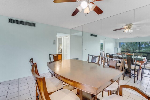 dining room featuring ceiling fan, light tile patterned flooring, and track lighting