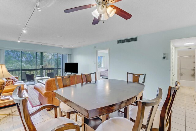 tiled dining area with ceiling fan