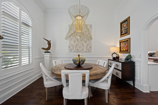 dining room with dark hardwood / wood-style flooring and ornamental molding