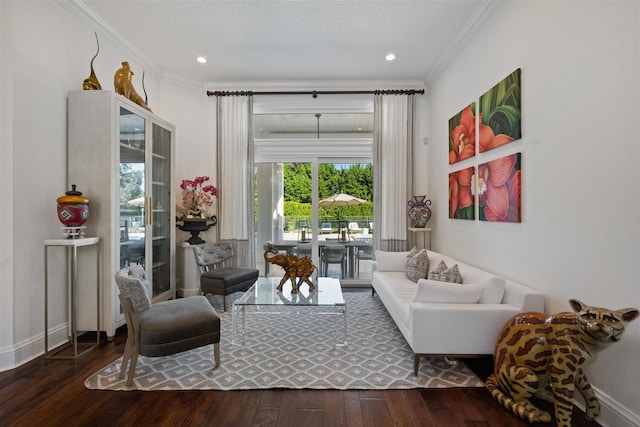 sitting room with wood-type flooring and ornamental molding