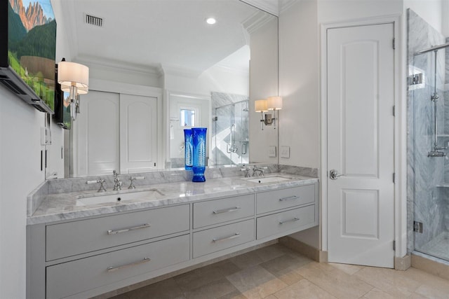 bathroom with vanity, a shower with door, and crown molding