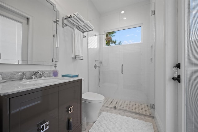 bathroom featuring toilet, vanity, tile patterned floors, and an enclosed shower