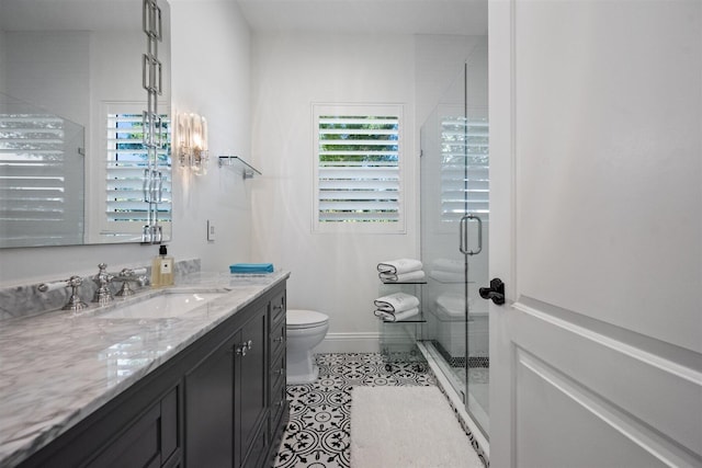 bathroom featuring tile patterned floors, toilet, vanity, and walk in shower