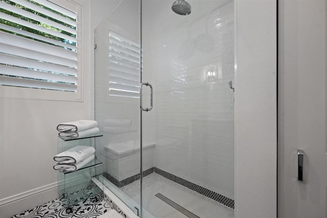 bathroom with tile patterned flooring and a shower with shower door