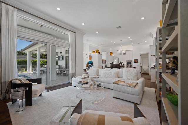 living room featuring wood-type flooring and crown molding