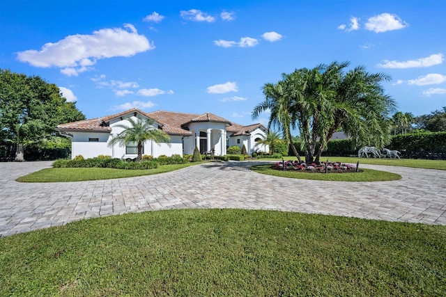 mediterranean / spanish-style home featuring a front yard