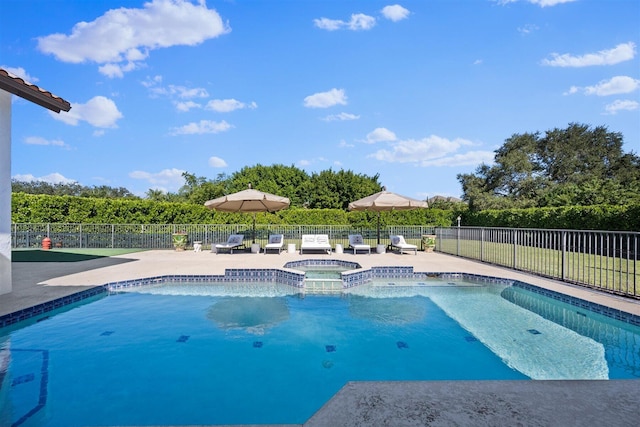 view of pool with an in ground hot tub and a patio