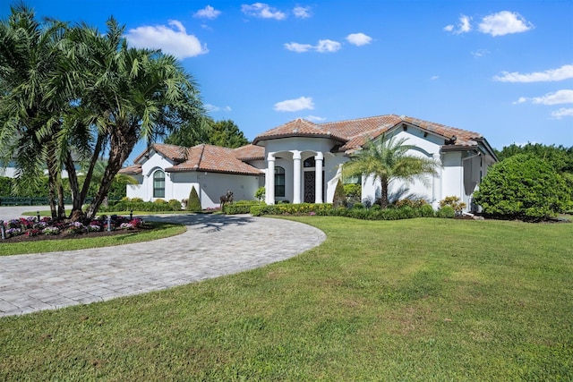 mediterranean / spanish house featuring a front yard