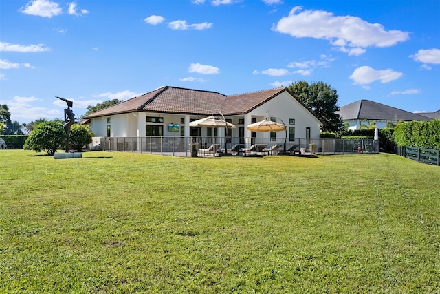 rear view of property with a yard