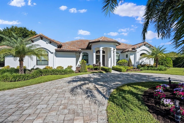 mediterranean / spanish house with a front yard