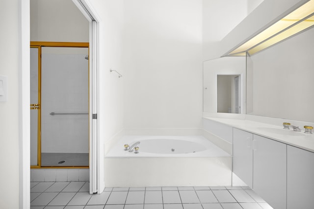 bathroom featuring tile patterned flooring, vanity, and separate shower and tub