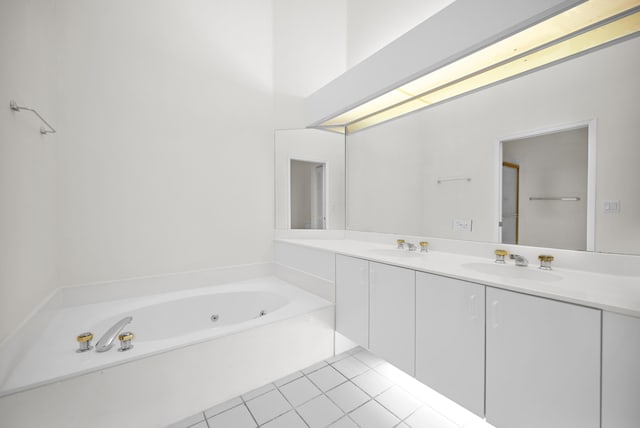 bathroom featuring vanity, tile patterned floors, and a tub