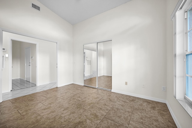 unfurnished bedroom with lofted ceiling