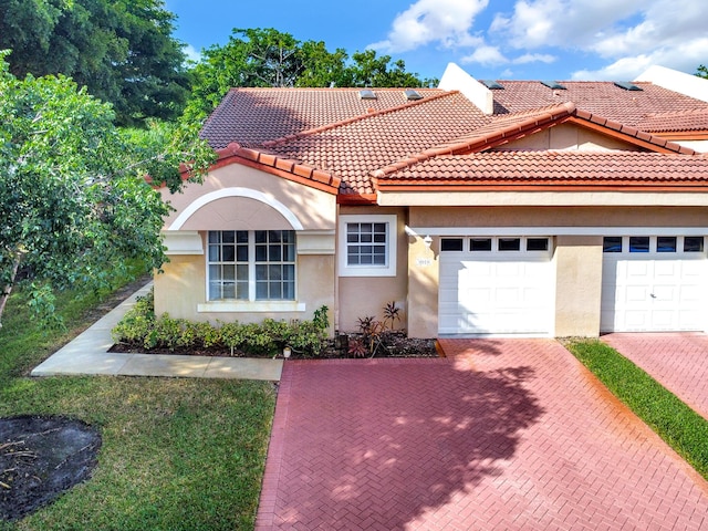 mediterranean / spanish-style house featuring a garage