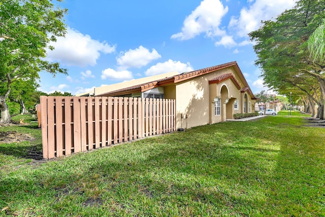 view of side of home featuring a yard