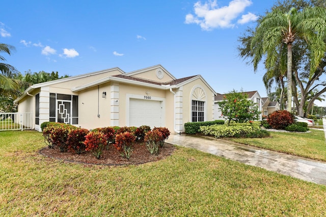 single story home with a garage and a front lawn