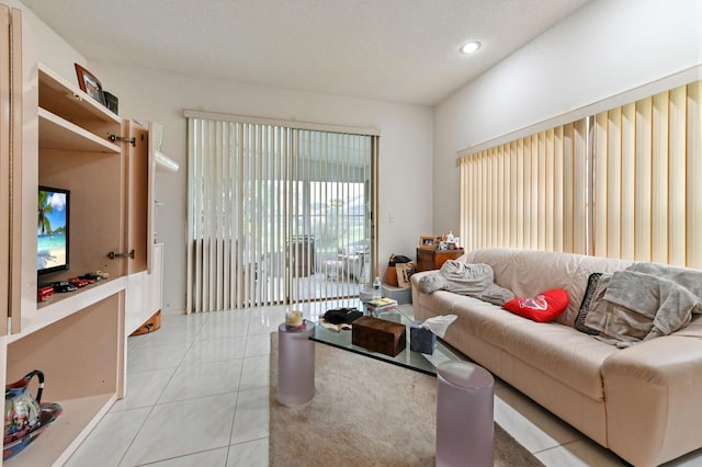 living room with light tile patterned floors and a textured ceiling