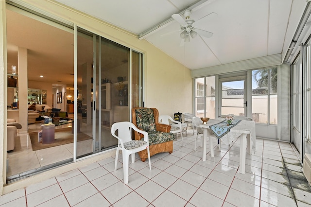 sunroom featuring lofted ceiling with beams and ceiling fan