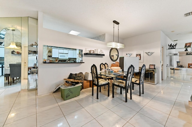 dining space featuring light tile patterned floors