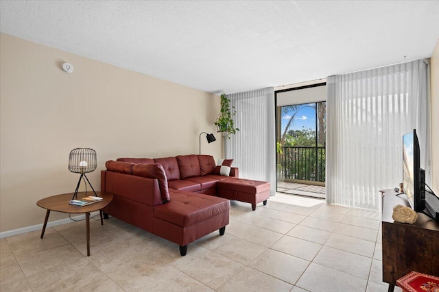 living room with light tile patterned floors, floor to ceiling windows, and a textured ceiling